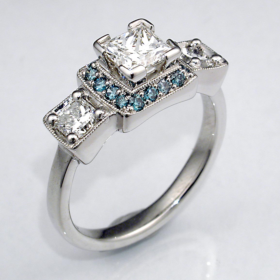 Three Stone Diamond Engagement Ring w/Blue Diamond Halo - DeSantis